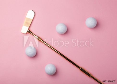Picture of luxury golden golf club with golf balls isolated on pink background